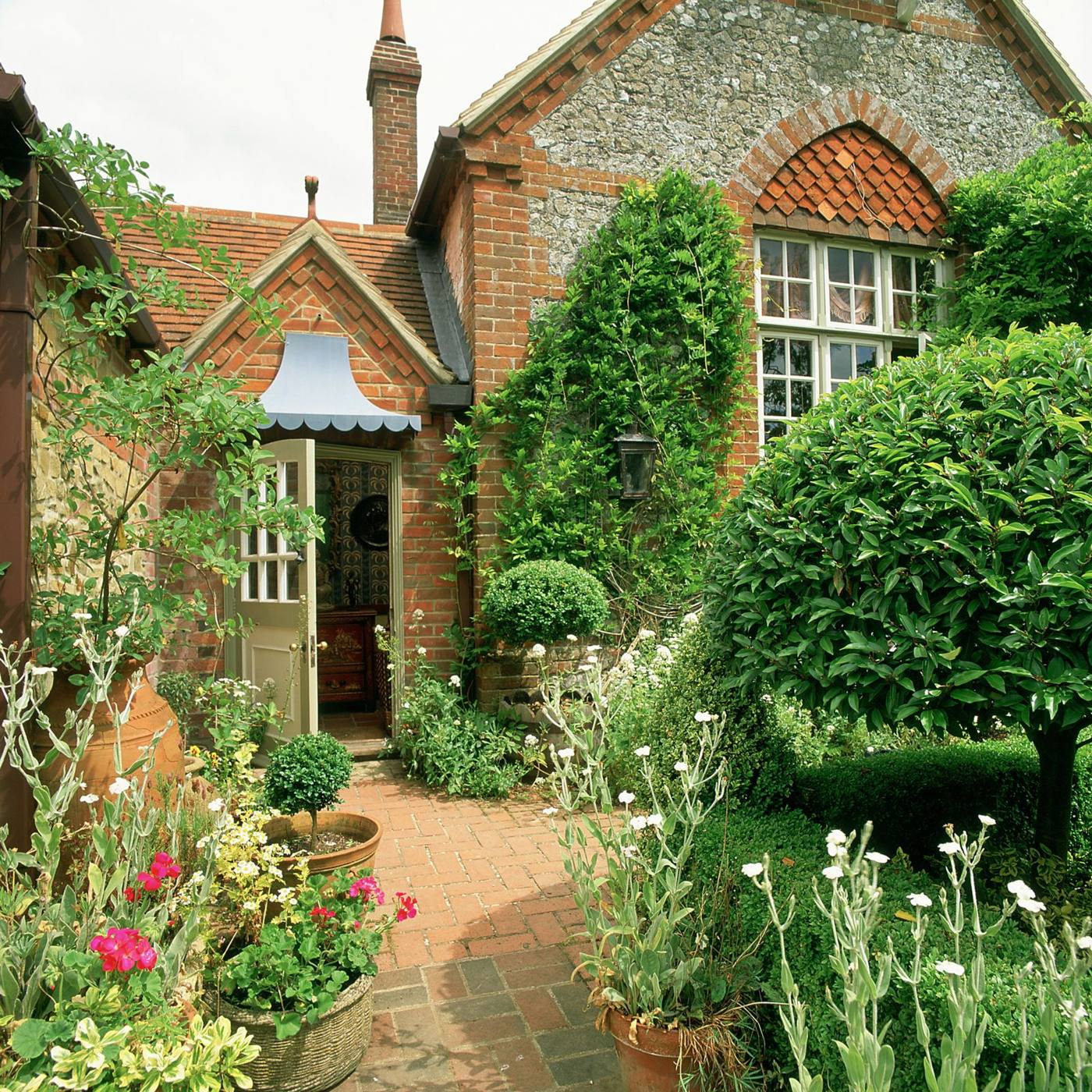 English cottage front garden with a clean brick path