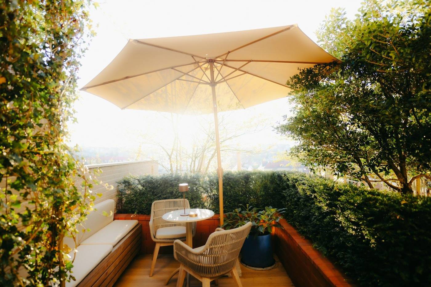 Wooden decking with garden furniture and parasol