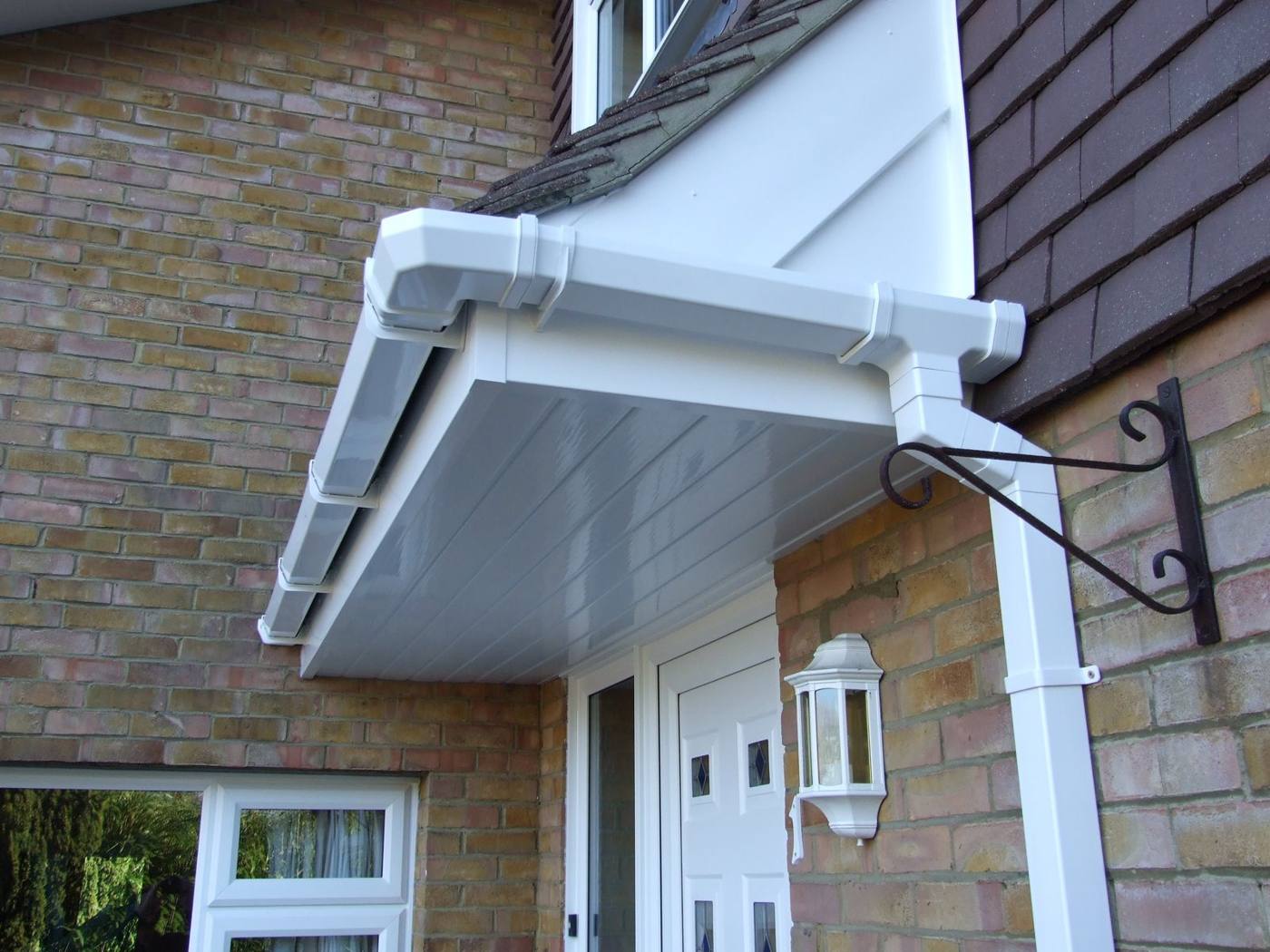 Clean white fascias, soffits and gutter over a porch