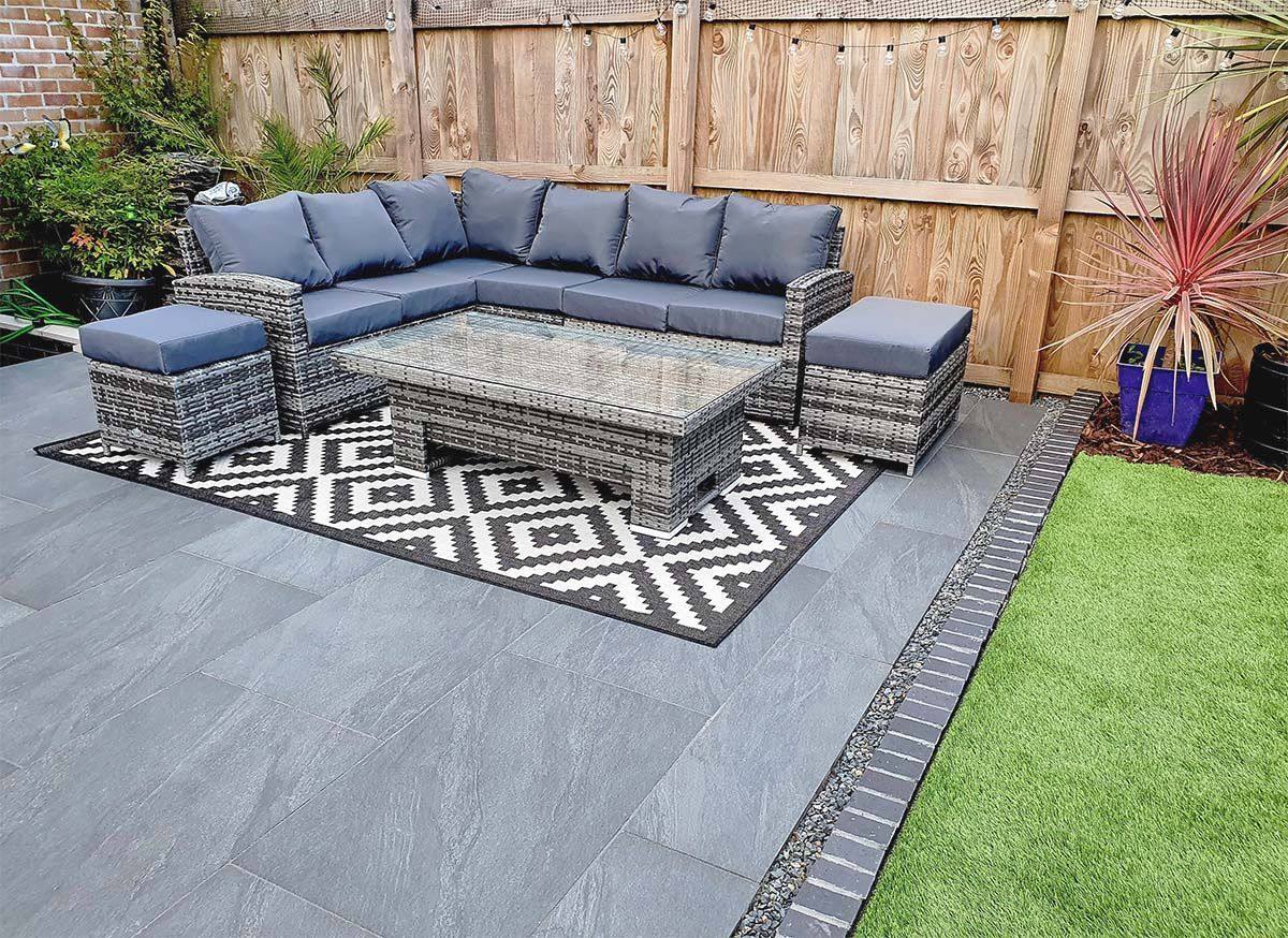 Clean porcelain patio with garden furniture