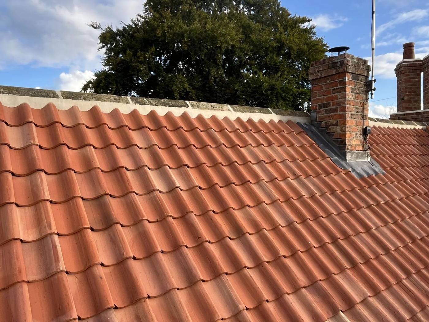 Clean clay pantile roof with chimney