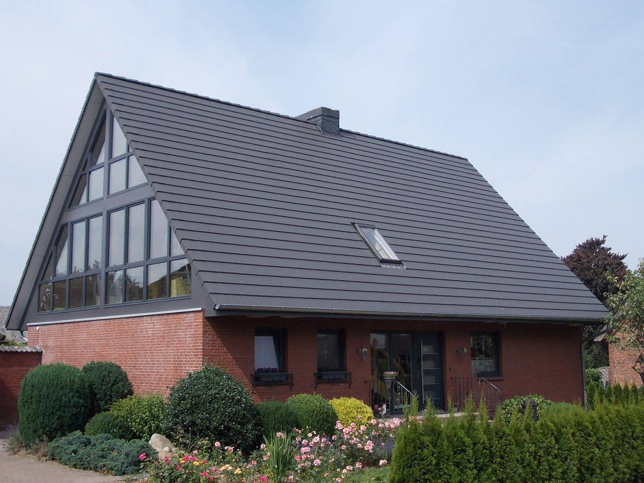 House with clean dark grey tiled roof