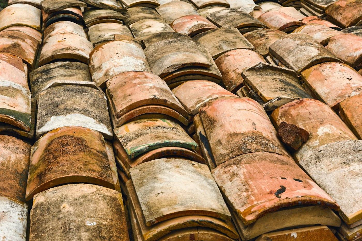 Weathered terracotta roof tiles close-up