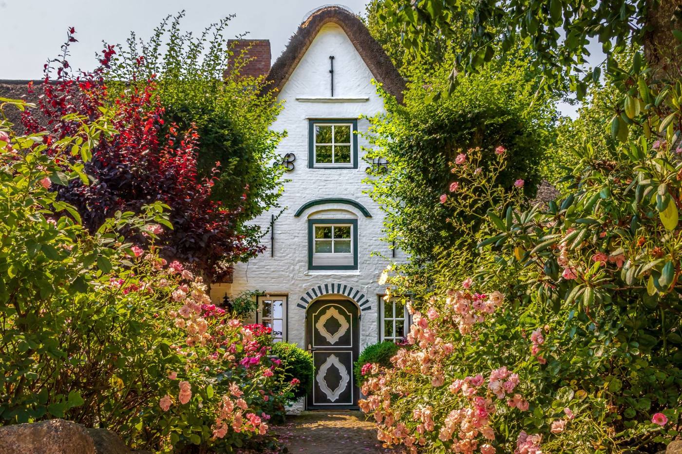 White rendered cottage with garden